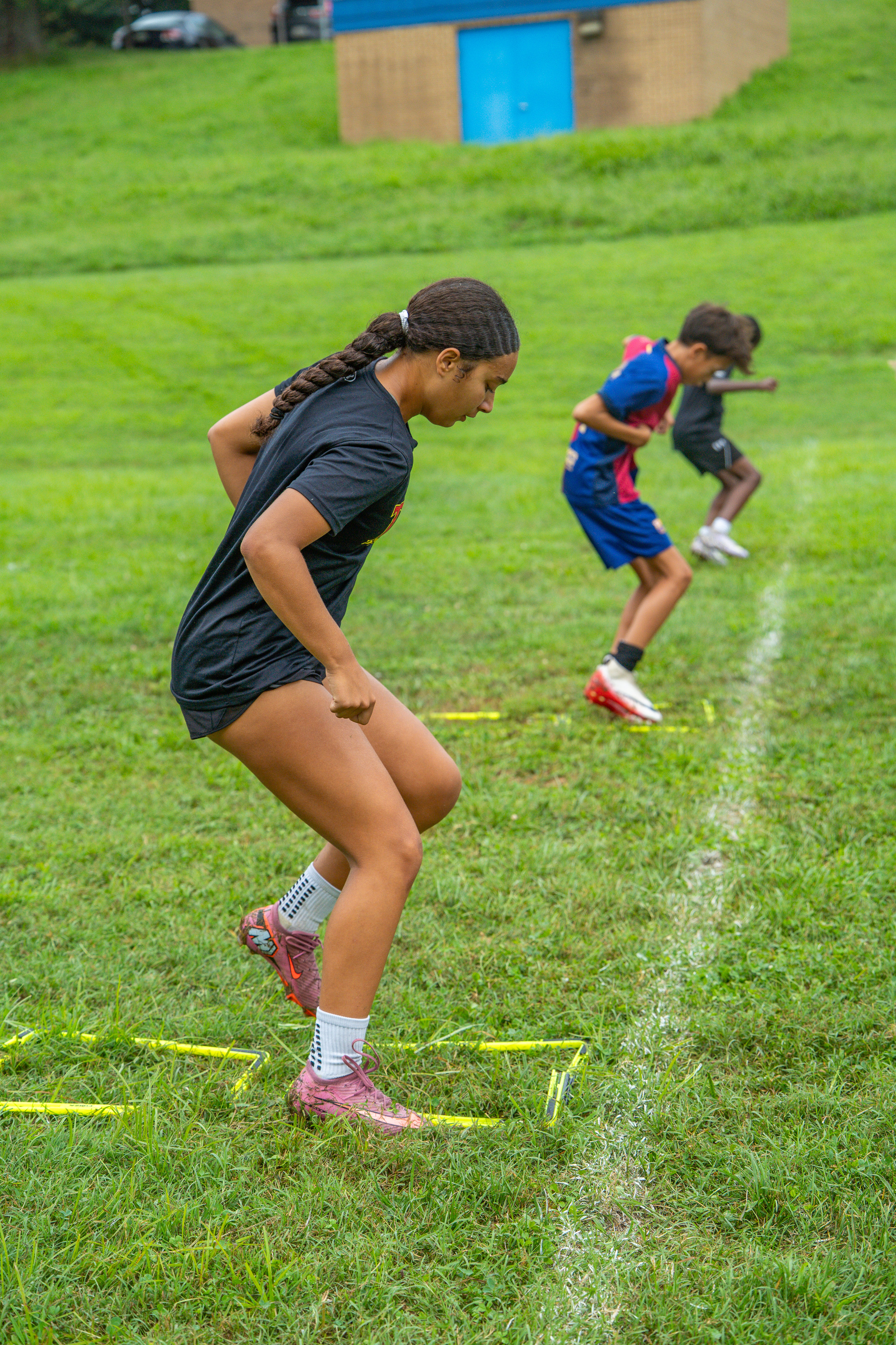 Players working through agility ladder drills